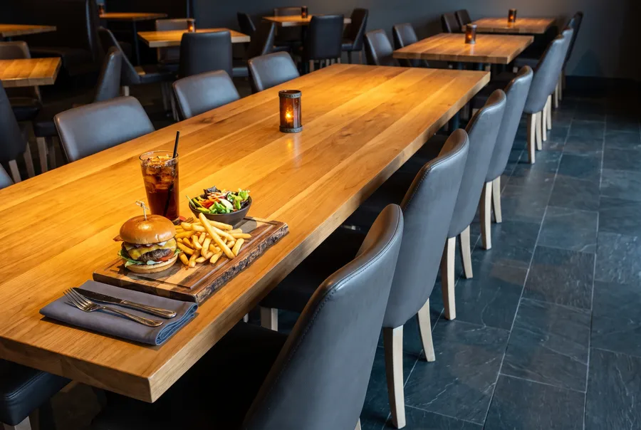 Burger and fries on a wooden table at MATCH